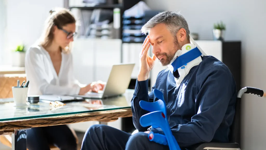 Injured person with neck brace consulting with a professional
