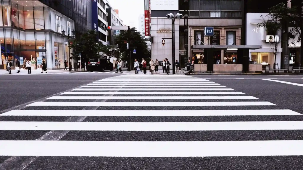 View of a crosswalk with pedestrians crossing in an urban area