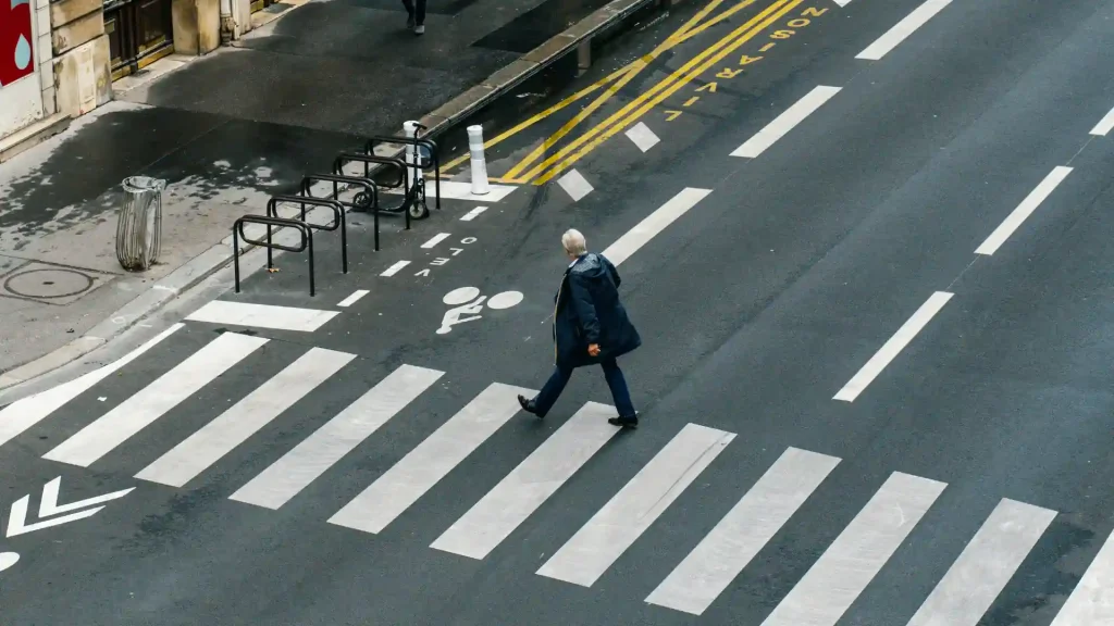 Person walking across a crosswalk in an urban area