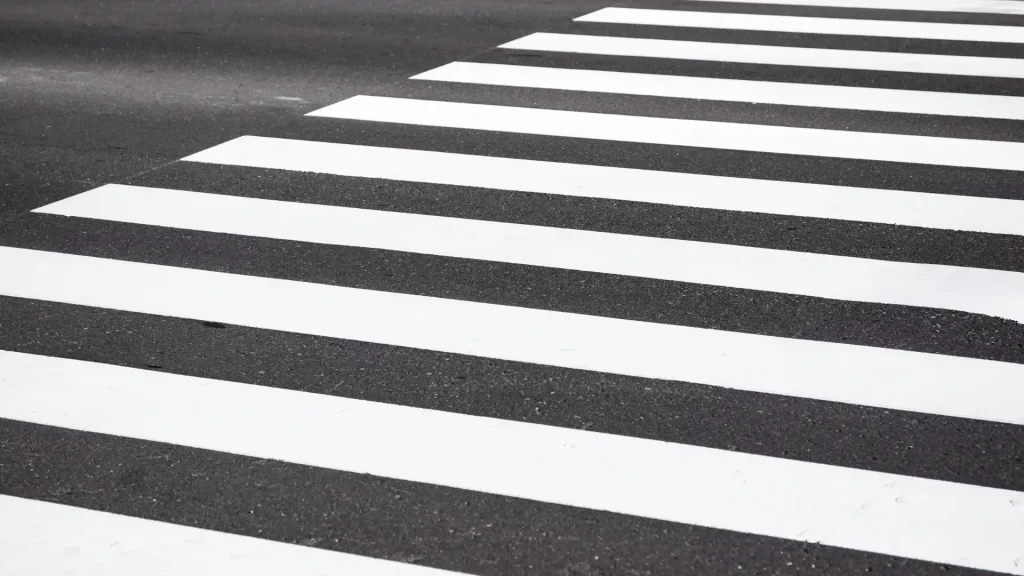 White-striped pedestrian crosswalk on asphalt