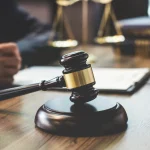 Wooden gavel on block during law office consultation