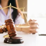 Gavel and scales on desk during client consultation