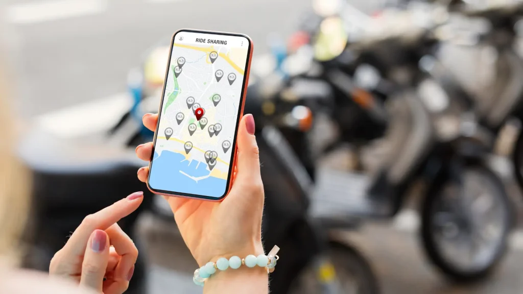 Person holding phone with rideshare app open