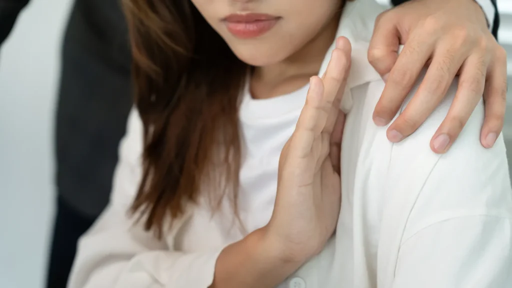 Woman raising hand to refuse unwanted touch