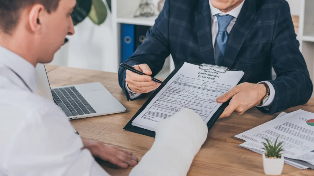 Lawyer showing a document to a client with an arm cast.