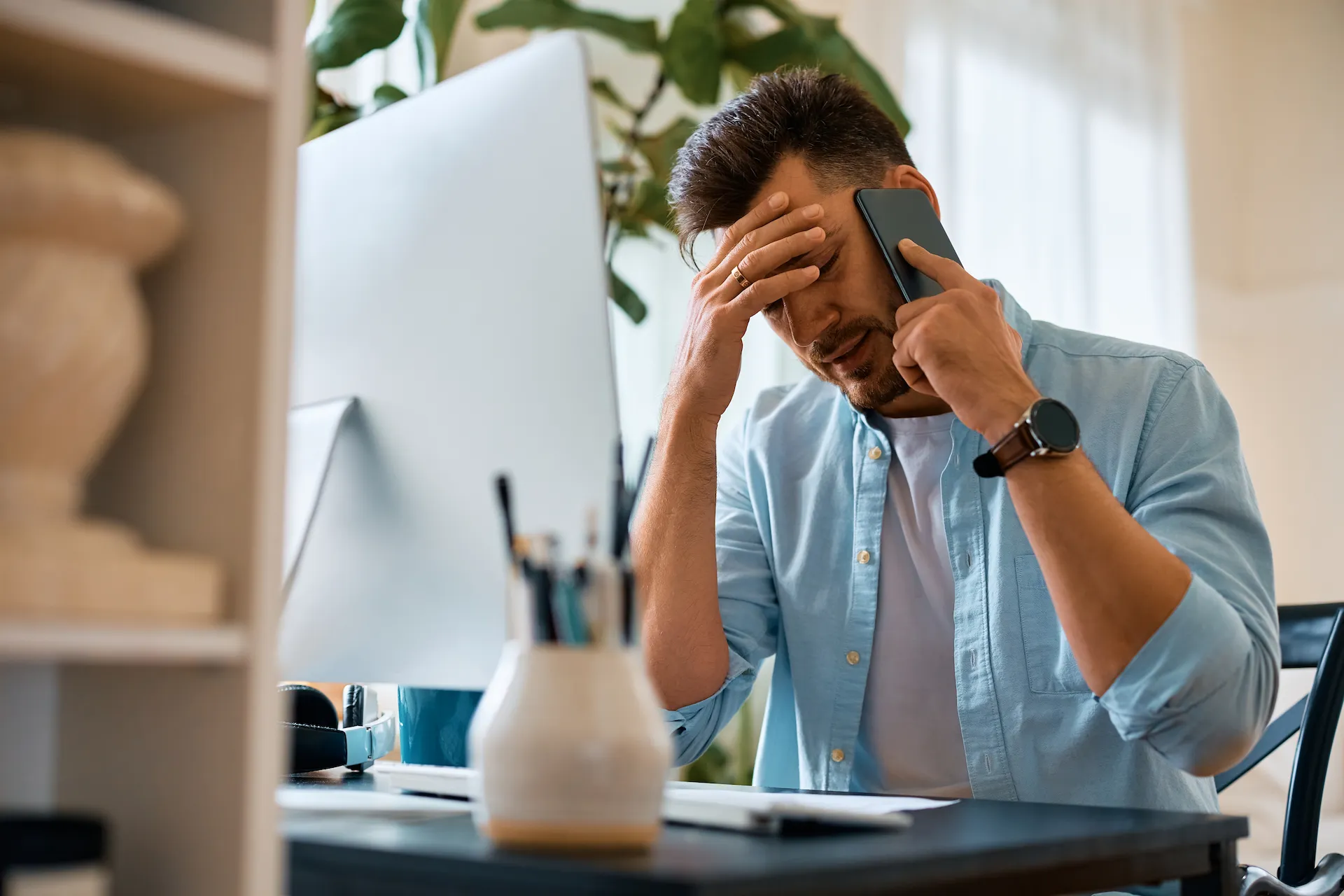 frustrated man on a phone call