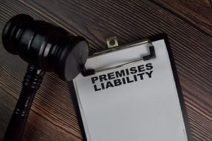 Gavel and premises liability clipboard lying on a desk.